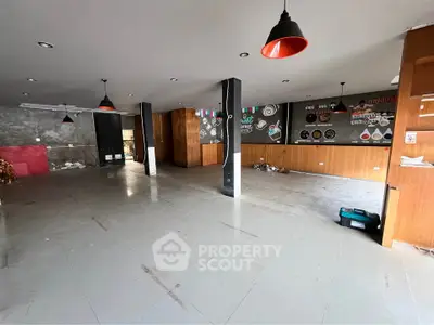 Spacious commercial space with modern lighting and open layout, ideal for business setup.