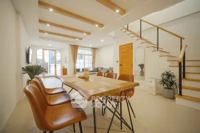 Spacious modern living room with stylish dining area and staircase