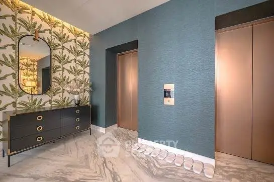 Stylish modern elevator lobby with chic decor and elegant marble flooring.