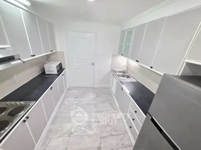 Modern kitchen with sleek cabinetry and stainless steel appliances in a spacious layout.