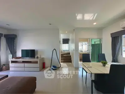 Spacious modern living room with dining area and natural light