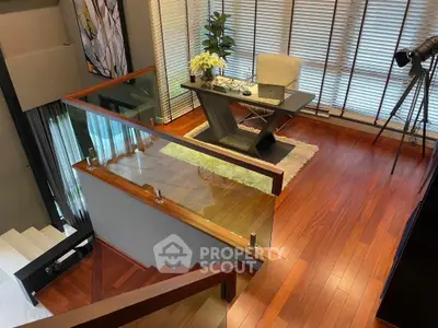 Modern home office with sleek wooden flooring and stylish desk setup