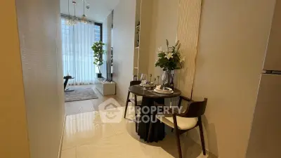 Modern dining area with elegant table setting and view into stylish living room.