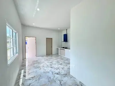 Spacious modern kitchen with marble flooring and ample natural light