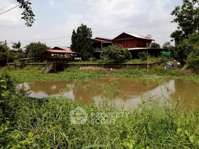 Charming rural property with lush greenery and serene water view, perfect for nature lovers.