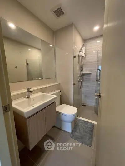 Modern bathroom with sleek fixtures and glass shower enclosure