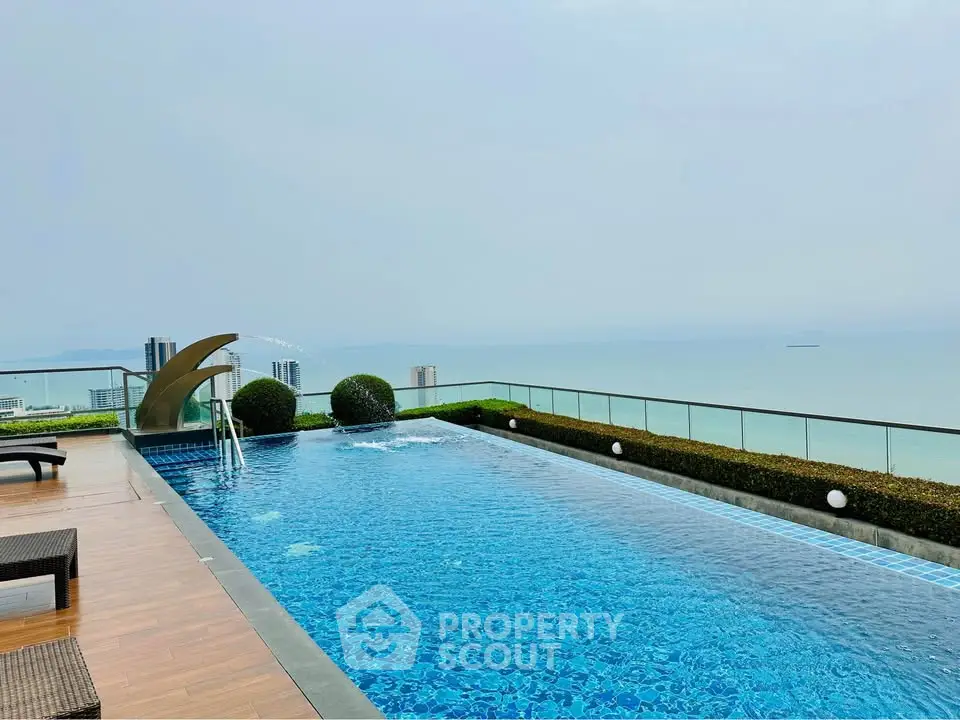 Stunning rooftop pool with panoramic ocean view in luxury real estate setting.