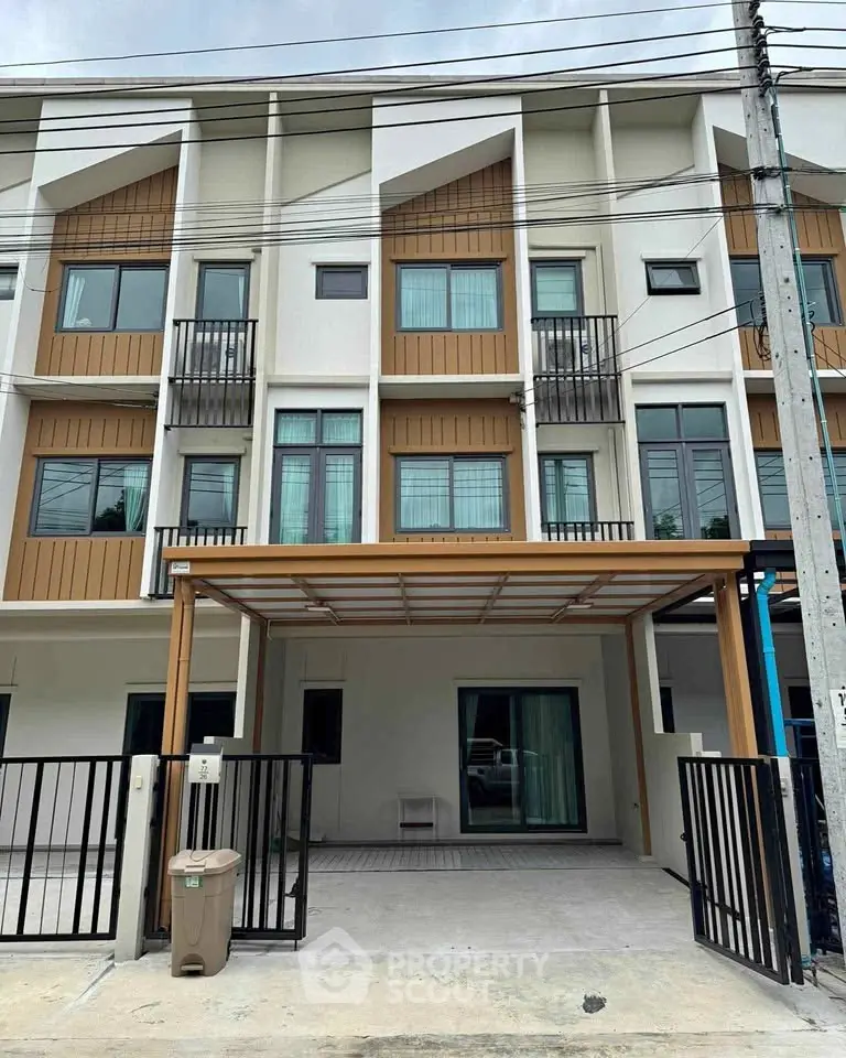 Modern townhouse exterior with stylish facade and small balconies