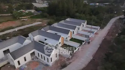 Aerial view of modern single-story homes in a serene suburban neighborhood.