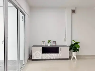 Modern minimalist interior with sleek cabinet and sliding glass doors