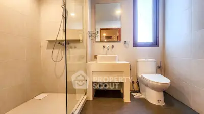 Modern bathroom with sleek fixtures and large shower area in a contemporary home.
