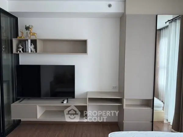 Modern living room with sleek TV unit and decorative shelves