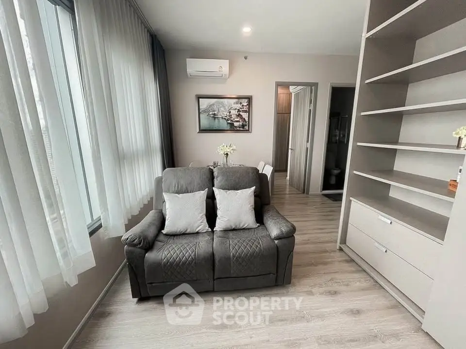 Modern living room with cozy sofa and stylish decor in a bright apartment.