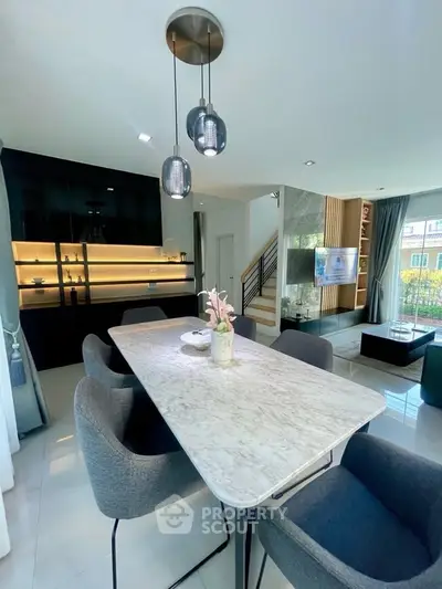 Modern open-plan living and dining area with stylish decor and natural light.