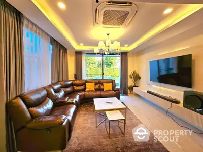 Luxurious living room with leather sofa and modern entertainment setup