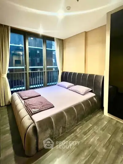 Luxurious bedroom with modern decor and large windows for natural light.