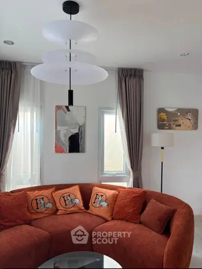 Stylish living room with modern circular sofa and elegant decor