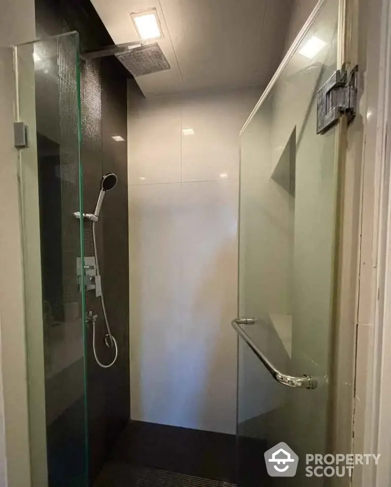 Modern bathroom with sleek glass shower enclosure and rainfall showerhead