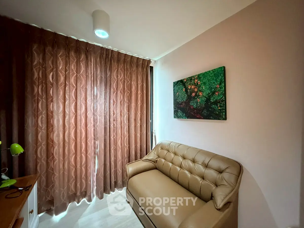Cozy living room with elegant sofa and artistic wall decor, perfect for relaxation.