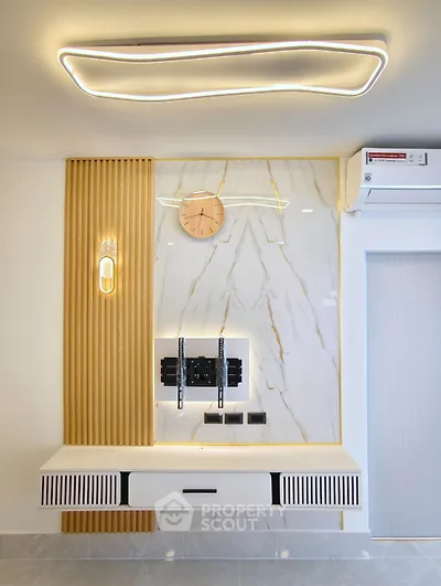 Modern living room with stylish wall paneling and sleek lighting design