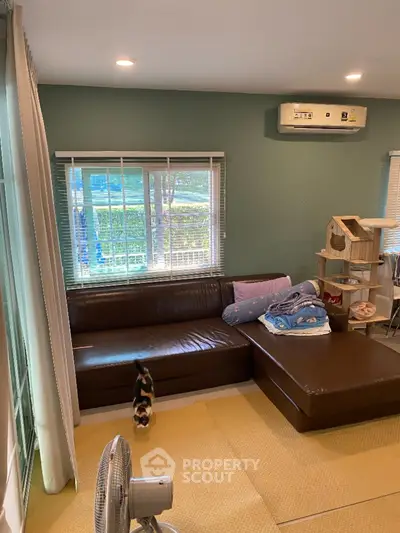 Cozy living room with sectional sofa and large window