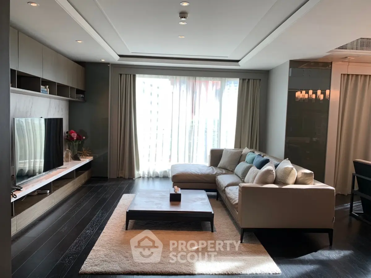 Luxurious modern living room with elegant decor and ample natural light.