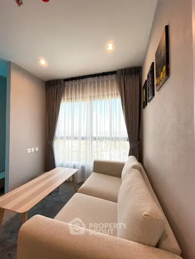 Modern living room with large window and cozy beige sofa