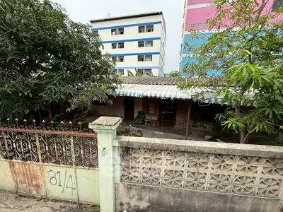 Charming fixer-upper house with potential, nestled in a lush garden setting, ideal for renovation enthusiasts.