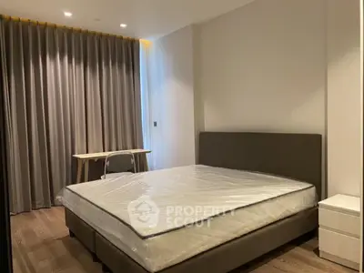 Modern bedroom with large bed and stylish curtains, perfect for relaxation and comfort.
