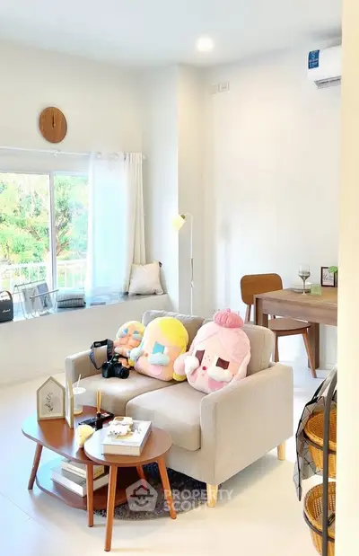 Charming living room with cozy sofa and plush decor, perfect for relaxation.