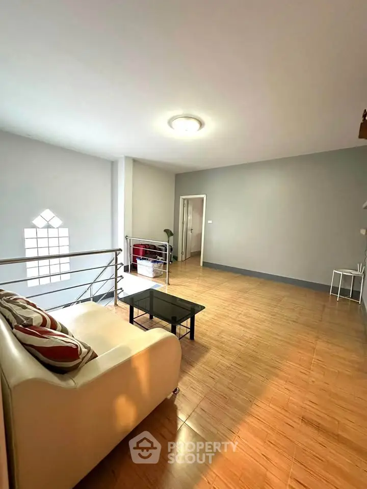 Spacious living room with modern decor and wooden flooring