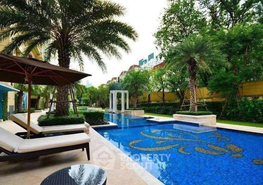 Luxurious outdoor pool area with elegant design and lush greenery, perfect for relaxation and leisure.