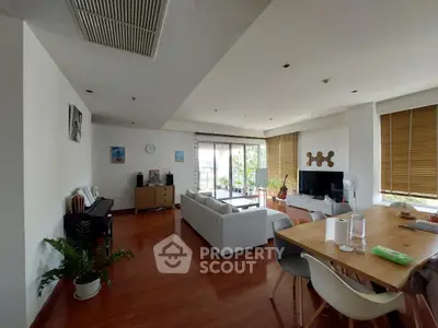 Spacious living room with modern decor and large windows offering natural light.