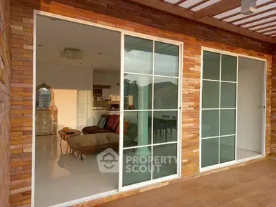 Charming home with sliding glass doors and cozy interior, perfect for modern living.
