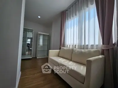 Bright and cozy living room with elegant sofa and large window