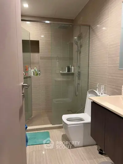 Modern bathroom with glass shower and sleek fixtures