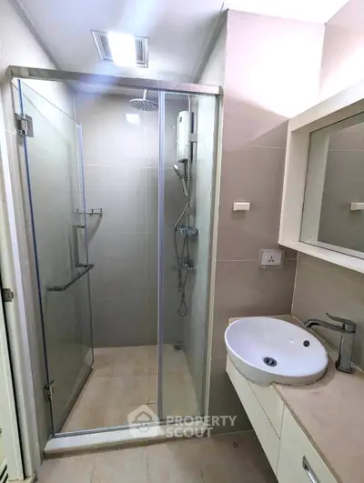 Modern bathroom with glass shower enclosure and sleek vanity
