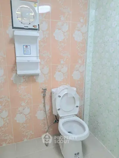 Modern bathroom with floral tiles and essential fixtures
