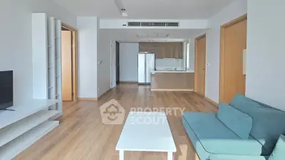 Modern living room with sleek furniture and open kitchen layout