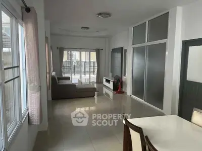 Spacious living room with modern decor and large windows for natural light.