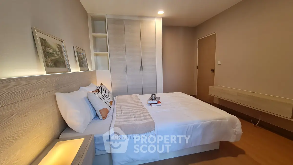 Modern bedroom with cozy bed and stylish decor in a contemporary apartment.