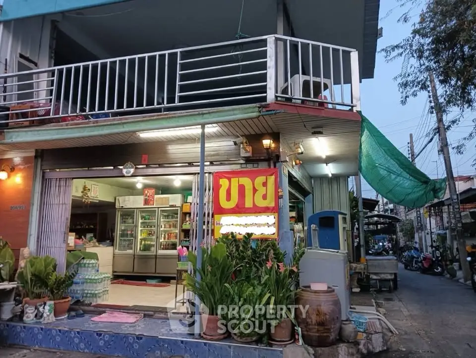 Charming street-side property with balcony and vibrant storefront, ideal for business opportunities.
