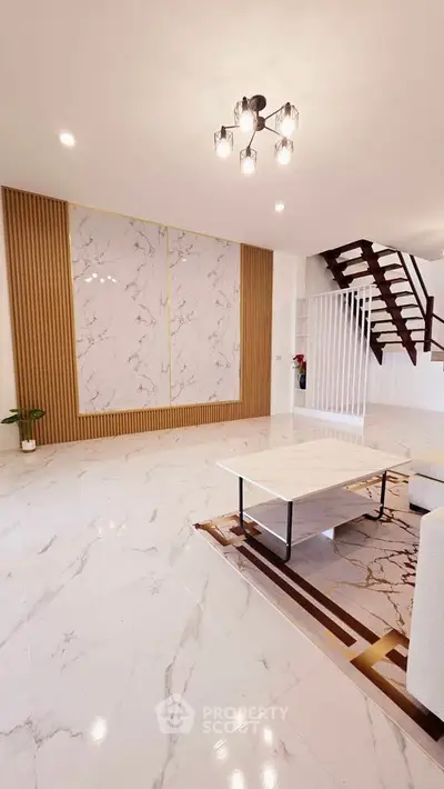 Elegant living room with marble flooring and modern staircase, perfect for stylish urban living.