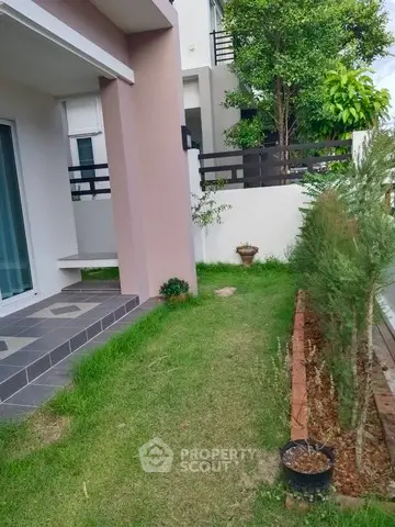 Charming garden view of modern home with lush greenery and stylish architecture.