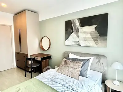 Modern bedroom with stylish decor and cozy bedding in a contemporary apartment.