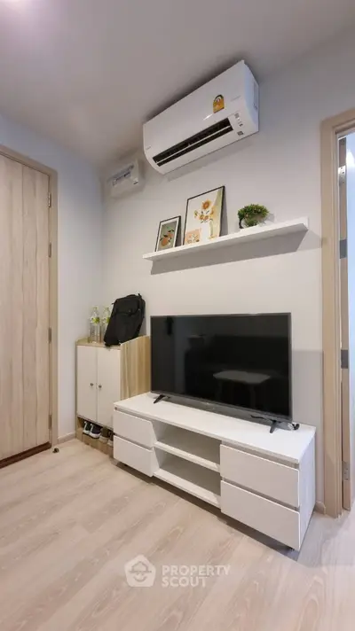Modern living room with sleek TV stand and air conditioning unit