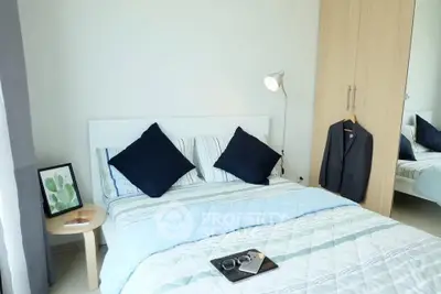 Cozy bedroom with stylish decor and ample natural light, featuring a comfortable bed and modern furnishings.