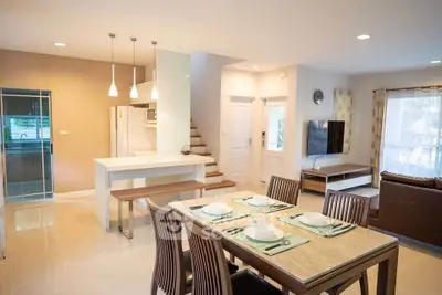 Modern open-plan living and dining area with stylish decor and natural light.