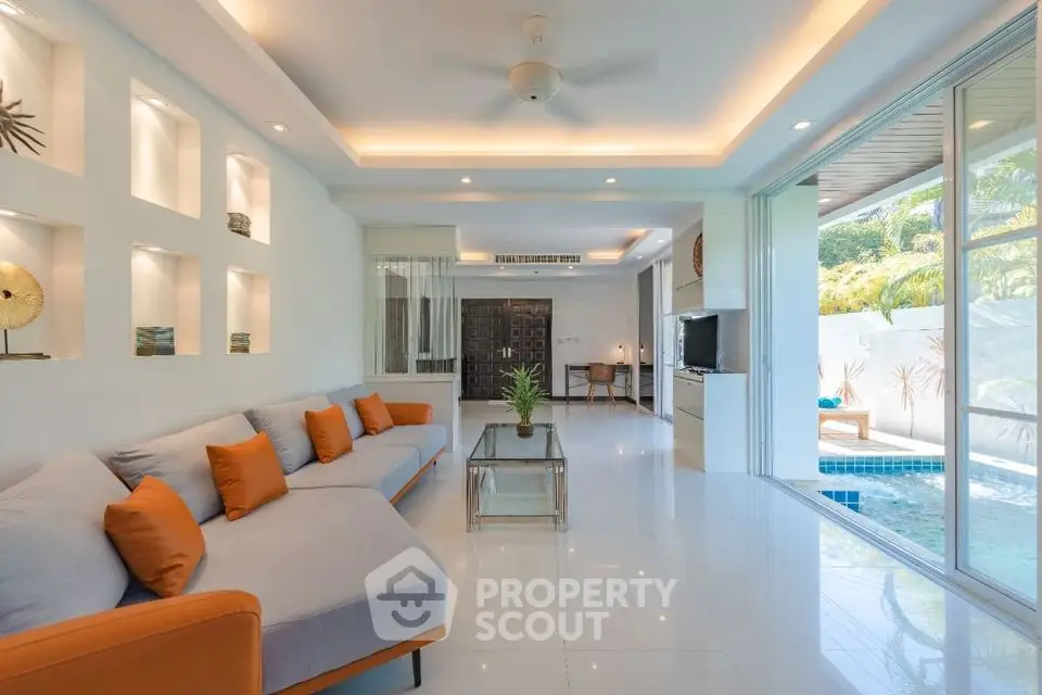 Luxurious living room with pool view and modern decor in tropical villa