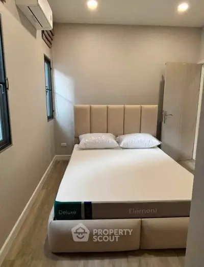 Cozy bedroom with modern decor and comfortable bed in a stylish apartment.